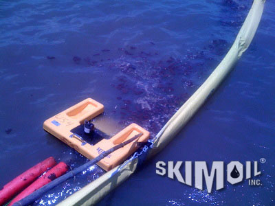 Oil spill with skimmer and boom in action